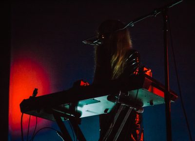 Side stage lighting reflecting off of Legrand’s leather suit.