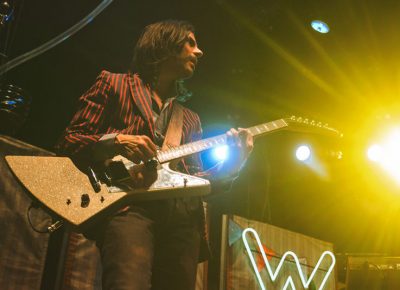 Brian Bell looks over to Cuomo while performing "Beverly Hills" with Weezer.