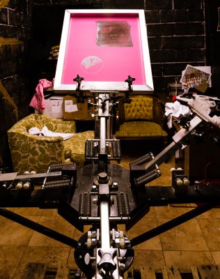 Goldblood Collective's trusty screen-printing machine. Photo by: Jennifer Thayn