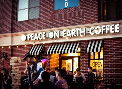 Small crowd of people gathering outside of Peace On Earth Coffee