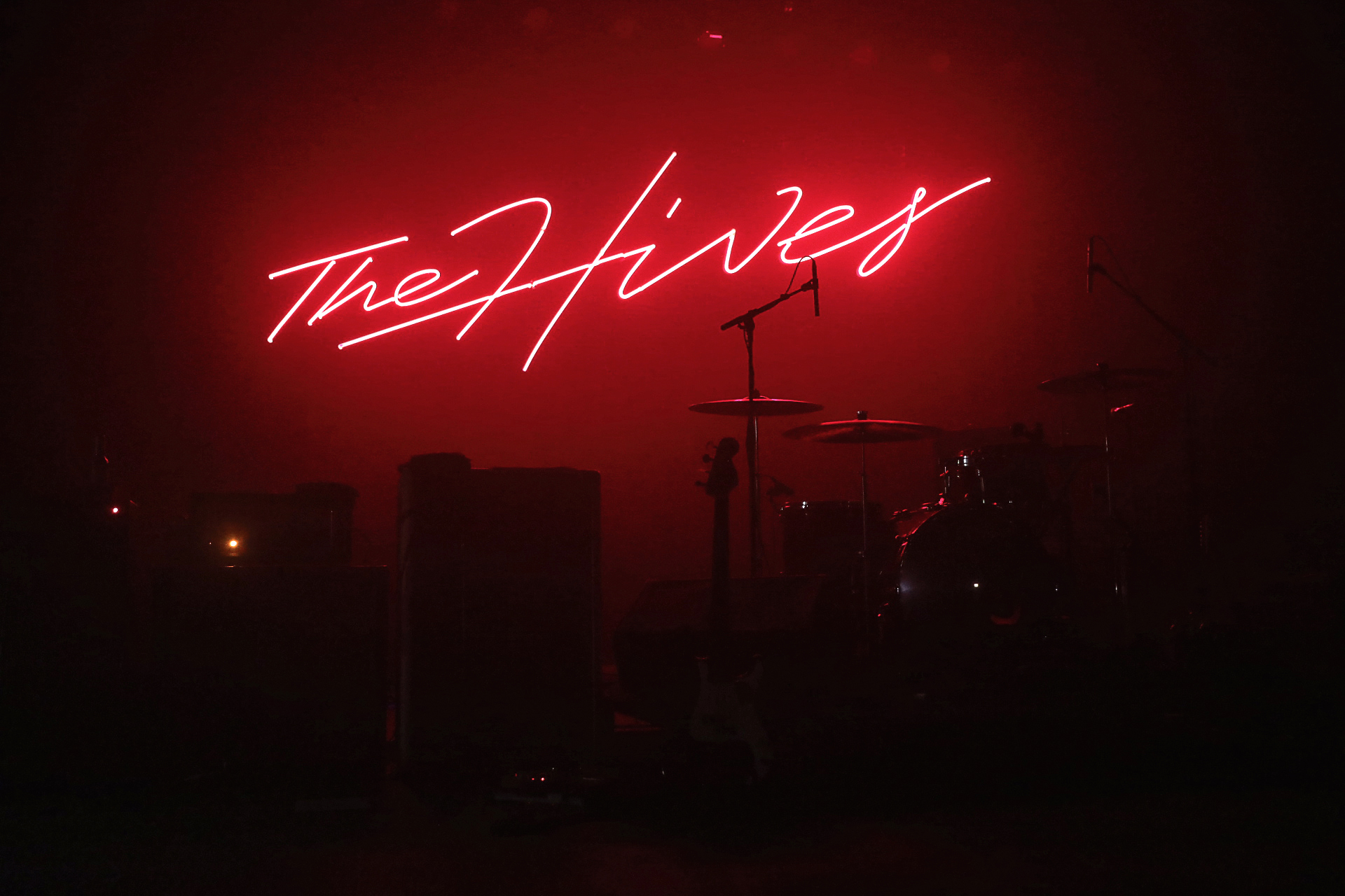 The Hives signage glowing behind the stage before the music begins. Photo: @Lmsorenson