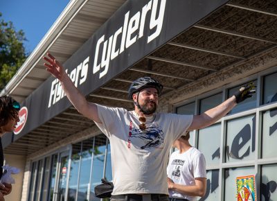 Christian Riley knocks out seven jumping jacks at Fishers Cyclery before earning a stamp on his manifest. Riley broke his chain right after this stop, but Fishers installed a fresh one to keep him in the race. Photo: Kaylynn Gonazlez