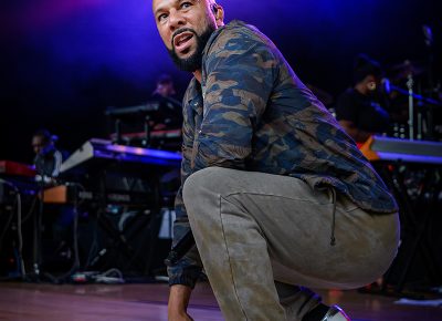 Common crouches in his Converses as he converses aloud to the crowd.