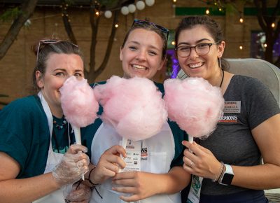 (L-R) Mindy Christensen, Ali Christensen, and Georgia Gamvroulas spin up some cotton candy for guests in the Harmons VIP Lounge at Craft Lake City. Ali is an expert with six months of cotton candy experience at Classic Fun Center.