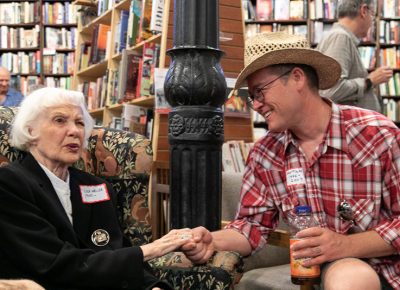 (L–R) Lila Weller shares a story with Mattson, who worked at the bookstore from 1996-2007. Mattson remembers sitting near Tony Weller’s desk as he and Sherry Zollinger wrote the bookstore’s newsletter. He’s particularly fond of an issue that included book reviews written by 13-year-old Lila Ann Weller and her teenage friend.