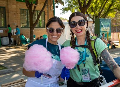 (L-R) Salt Lake City Councilwoman Ana Valdemoros serves cotton candy to Craft Lake City Executive President Angela Brown. Valdemoros has always dreamed of making cotton candy, and she also owns Argentine’s Best Empanadas, which served empanadas on the south side of the Dreamers Building.