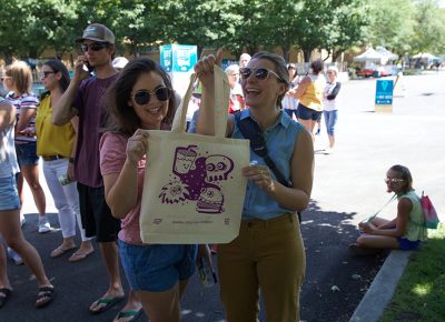Happy festival goers with their Copper Palate Press freshly printed totem bags.