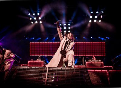 Masked lead vocalist Corey Taylor of Slipknot reaches out to as the crowd chants along.