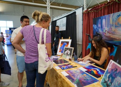 Halley Jean Bruno talking to some people about her art.