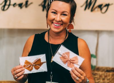Mackenzie Jones of Dear River May, shows off her signature children’s bows.