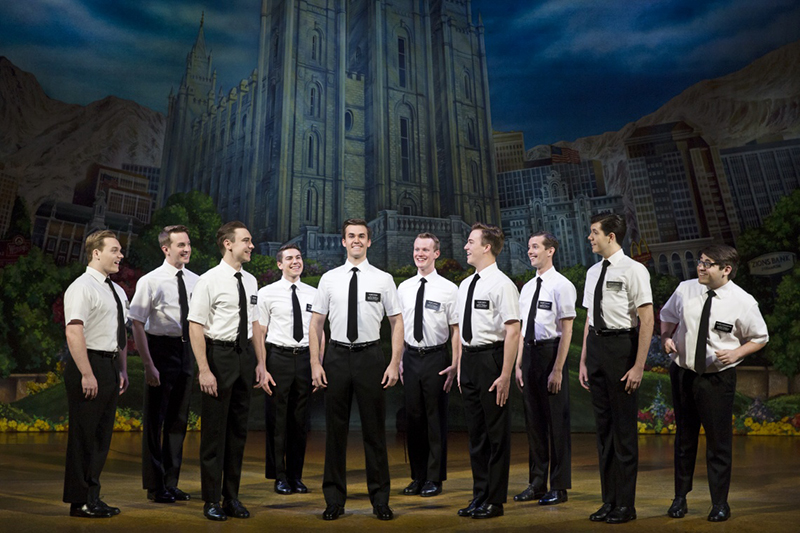 A shining group of missionaries on stage during The Book of Mormon at The Eccles Theater.