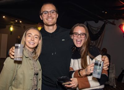 (L–R) Kyla Gibson, Mason Wright and Sarah Wright wait in line to have their Tarot cards read. Gibson went to the last Brewstillery at Trolley Square, so when she saw Boo!stillery advertised online, she “took a shot!”