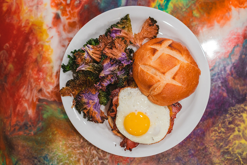 Roots Café's Utah Burger is topped with a succulent fried egg and goes great with baked kale.
