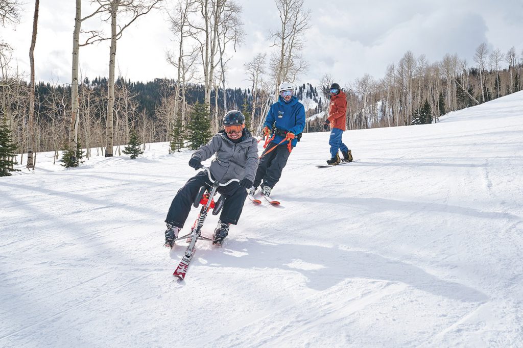 (L–R) Serei Panh, Ski, Snowboard Program Manager Brian Castillo and Snowboard Head Coach/Program Equipment Supervisor Colton Bradley enjoy riding at Park City Mountain as a part of the National Ability Center’s adaptive-recreation program.