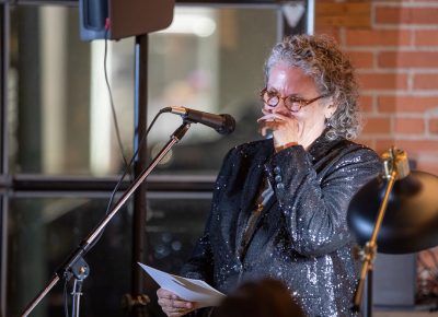 Lisa Bickmore introduces poet Samyek Shertok.