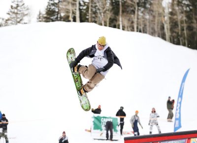 Boarder does a sick Toe-Side grab while coming in for a landing at the SLUG 20th Anniversary Meltdown Games at Brighton Resort.