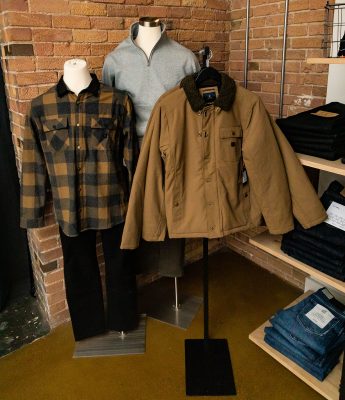 Coats and sweater on display for sale at The Stockist