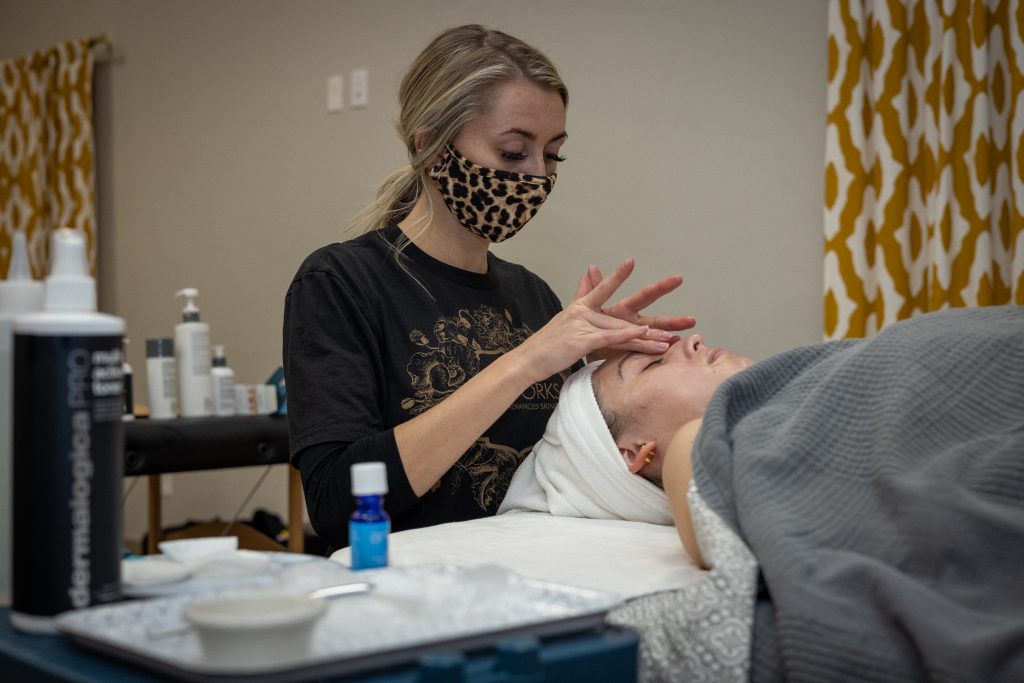 Skinworks student Alisha Steward (left) gives her first facial to a Skinworks client.
