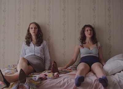 Our Father is a sardonically morose yet whimsically charming new film that rests on the shoulders of four women: sisters Beta and Zelda. (L–R) Baize Buzan as Beta and Allison Torem as Zelda.