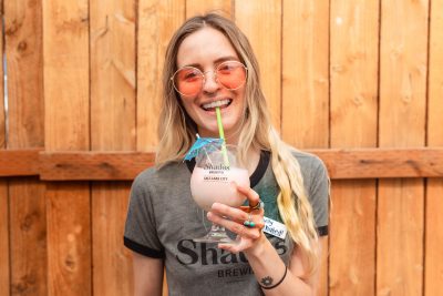 Shades General Manager Ellie Mcdonald sips on a Slushie, one of Shades’ sour beers that’s been transformed into slushy form, perfect for summer.