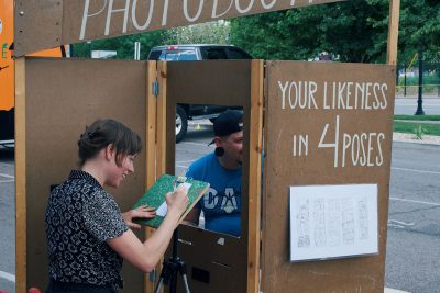 In between sets, the audience checks out the many local artisans such as the Hand Drawn Photo Booth.