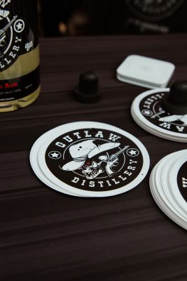 Outlaw Distillery's cowpoke logo brands their stickers.