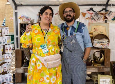 Jacqueline and Logan Whitmore of Copperhive Vintage enjoying a little shade in the comfort of their booth.
