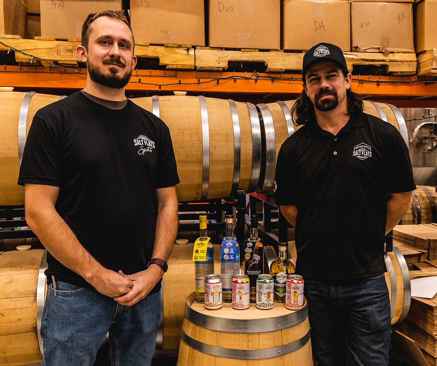 (L–R) Trent Moore and JC Straub of Salt Flats Spirits alongside the distillery’s product line.