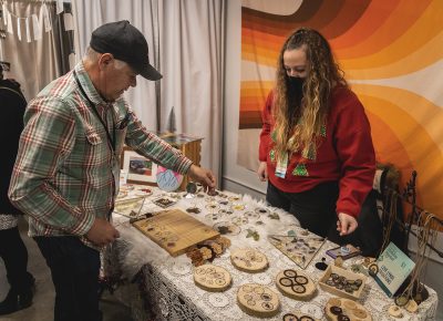 An attendee browsing an artisan's selection.