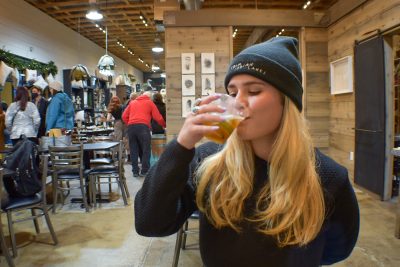 Patron Carlee Whalen enjoys a cocktail at Craft Lake City's 2021 Holiday Market.