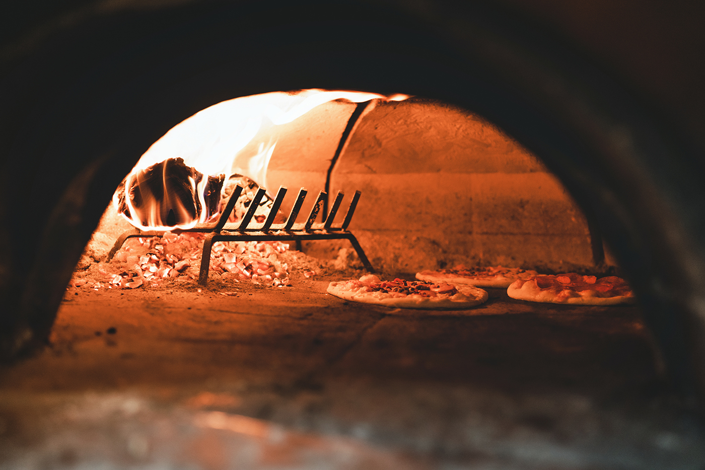 Brick oven cooking pizzas at Oakwood Fire Kitchen