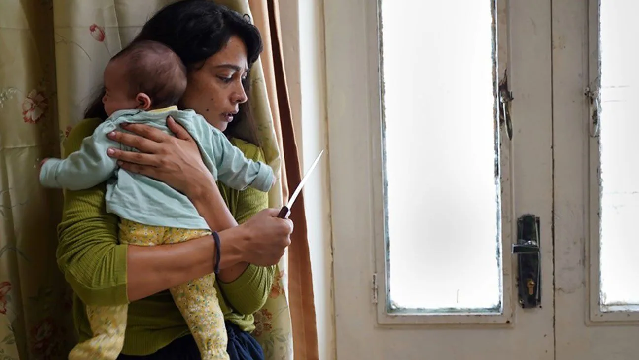 Still of Maisa Abd Elhadi holding baby in Huda's Salon