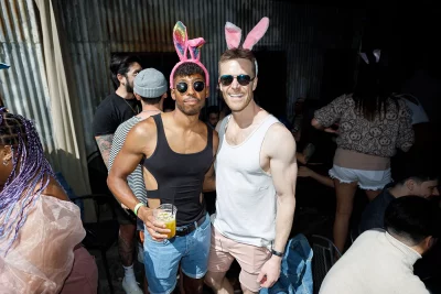 Two people wearing tank tops posing at the Bunny Hop with matching headwear.
