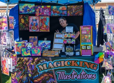 Suzanne King, owner of Magic King Illustrations, gives a peace sign and a smile.