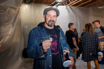 With a bucket of logo guitar picks in hand, Charles Thorpe prepares to welcome guests to an open house at Space & Faders, his boutique rehearsal space and photo studio.
