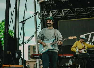 Guitarist smiles at crowd during live show