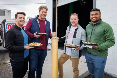 (L–R) Matt Elnour, Ryan Taylor, Kent Losser and Guru Prasad load up plates of Red Iguana’s signature dishes. Taylor designed the Eggs in the City, which is owned by Heather Santi, who is married to Thrope.
