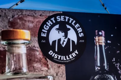 Eight Settlers Distillery logo on display at their Brewstillery booth