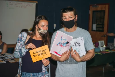 (L–R) Attendees Kiana Pennock and Zakk Reynolds show off the zines they found.