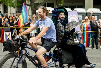 Steve from Saturday Cycles giving a ride to one of the parade's many queens.