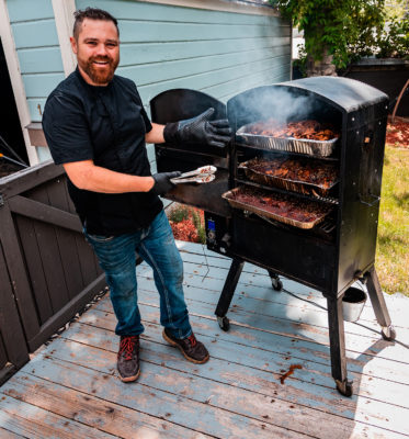 Christopher Blatchford smokes his veggie-based barbeque in his backyard with specialty, hand-made sauces and tasty spice mixtures.