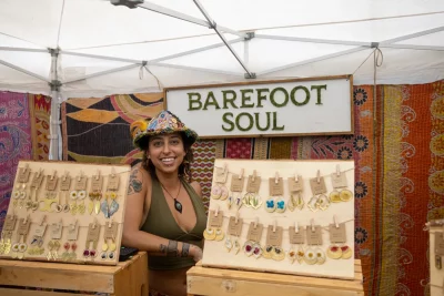 Barefoot Soul vendor smiling at handmade jewelry booth