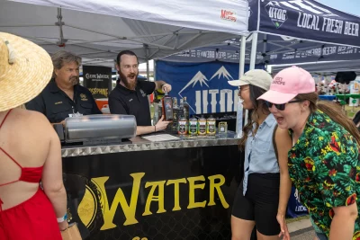 Clearwater Distillery vendors present bottle of alcohol to DIY Fest attendees