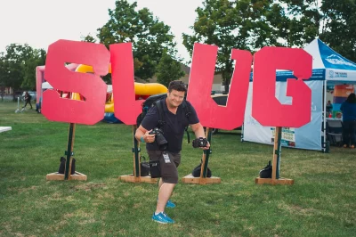 Longtime SLUG Mag contributor John Barkiple locked and loaded with film and digital cameras in front of the SLUG Mag stage sign. (Photo: @clancycoop)
