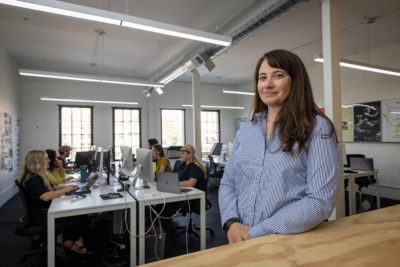 Jennifer Diehl, Managing Partner and Communications Director for Afton Klein Group (AKG), stands in AKG's open-office plan, which lets designers quickly collaborate. 
