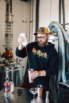 Michael Kunde of Proverbial Spirits pours a shot of Ain't No Rest For The Wicked Gin, one of Proverbial Spirits' two currently available spirits.