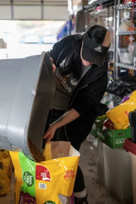 Frankie Brummett separates food donations at Best Friends Animal Society.