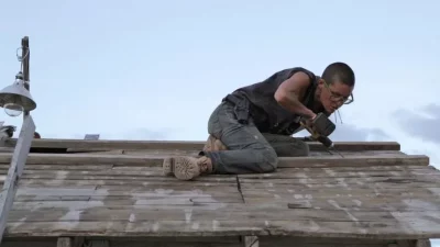 Eileen, the star of Emily Kaye Allen's Cisco Kid, works on a roof in their home town of Cisco, Utah.