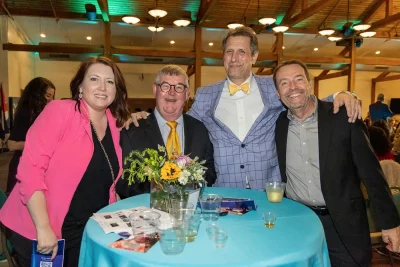Yellow ties and big smiles at this table kept the energy high at the Women of the World Annual Fashion Show and Cultural Gala. Photo: John Barkiple