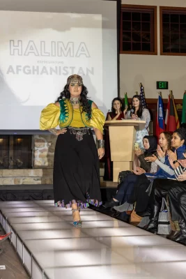 Halima from Afghanistan designed this traditional outfit that she’s wearing as she approaches the catwalk. Photo: John Barkiple